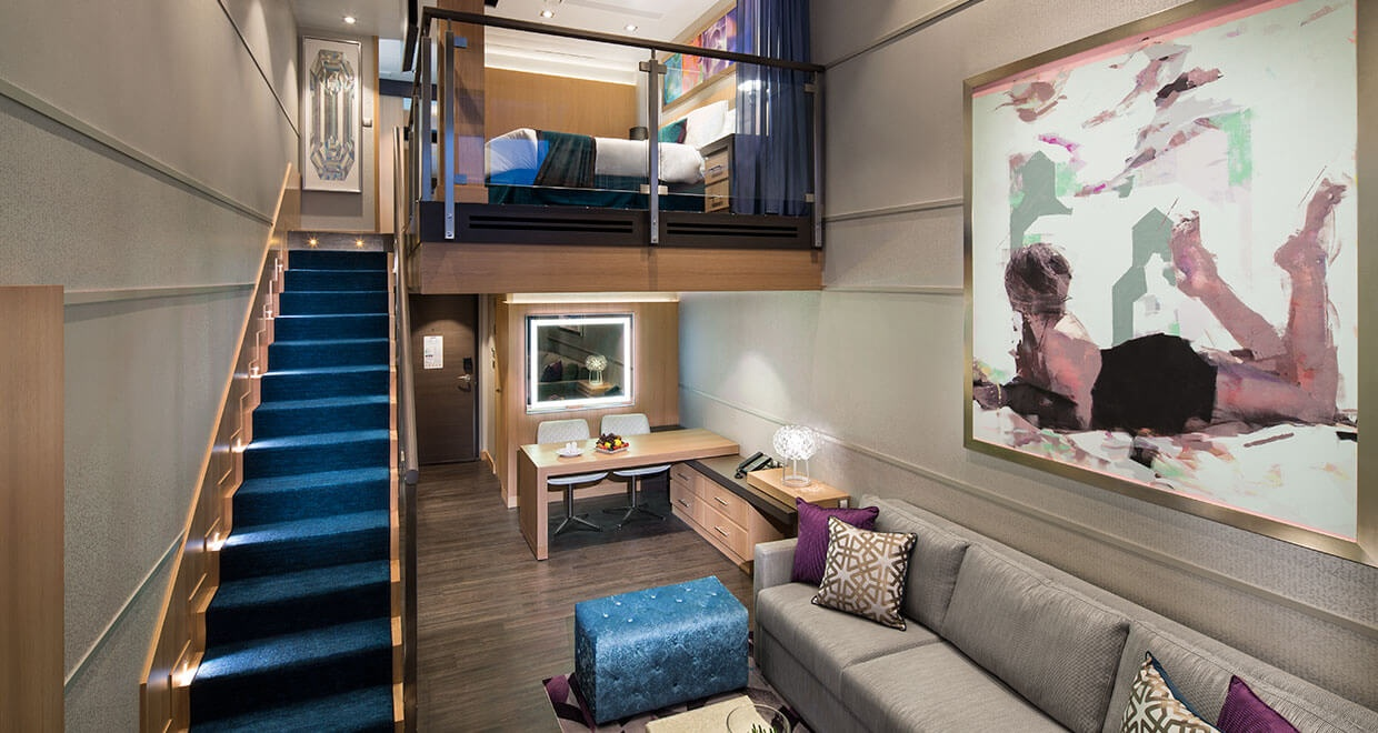 Royal Caribbean Crown Loft Suite with two-level living space, staircase, sofa, and loft bedroom