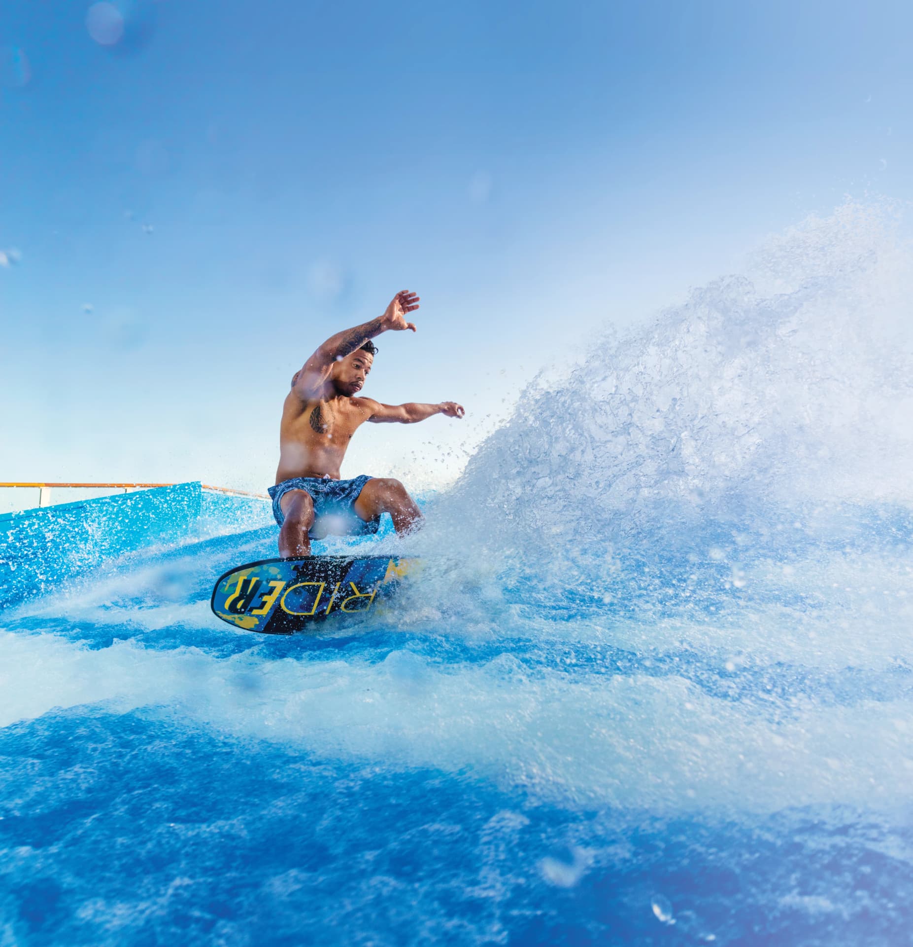 Guest surfing the FlowRider wave simulator on deck