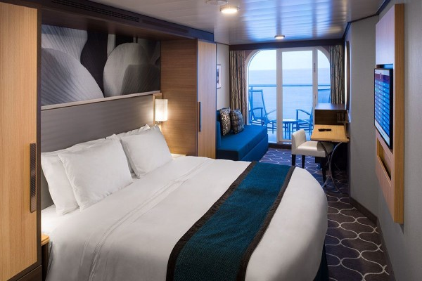 Ocean View Balcony cabin with king bed, private balcony, and ocean views aboard Oasis of the Seas